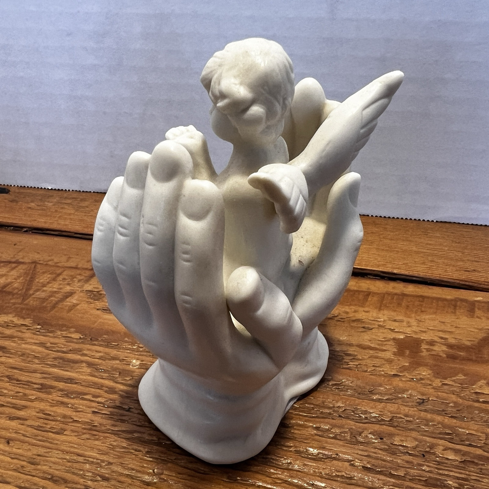 Vintage White Porcelain Figurine~Cherub Angel Sitting in Praying Hands~BEAUTIFUL