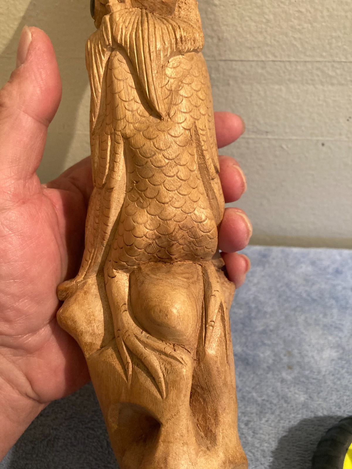 Owl bird statue hand carved from yellow natural wood with natural wood cracks