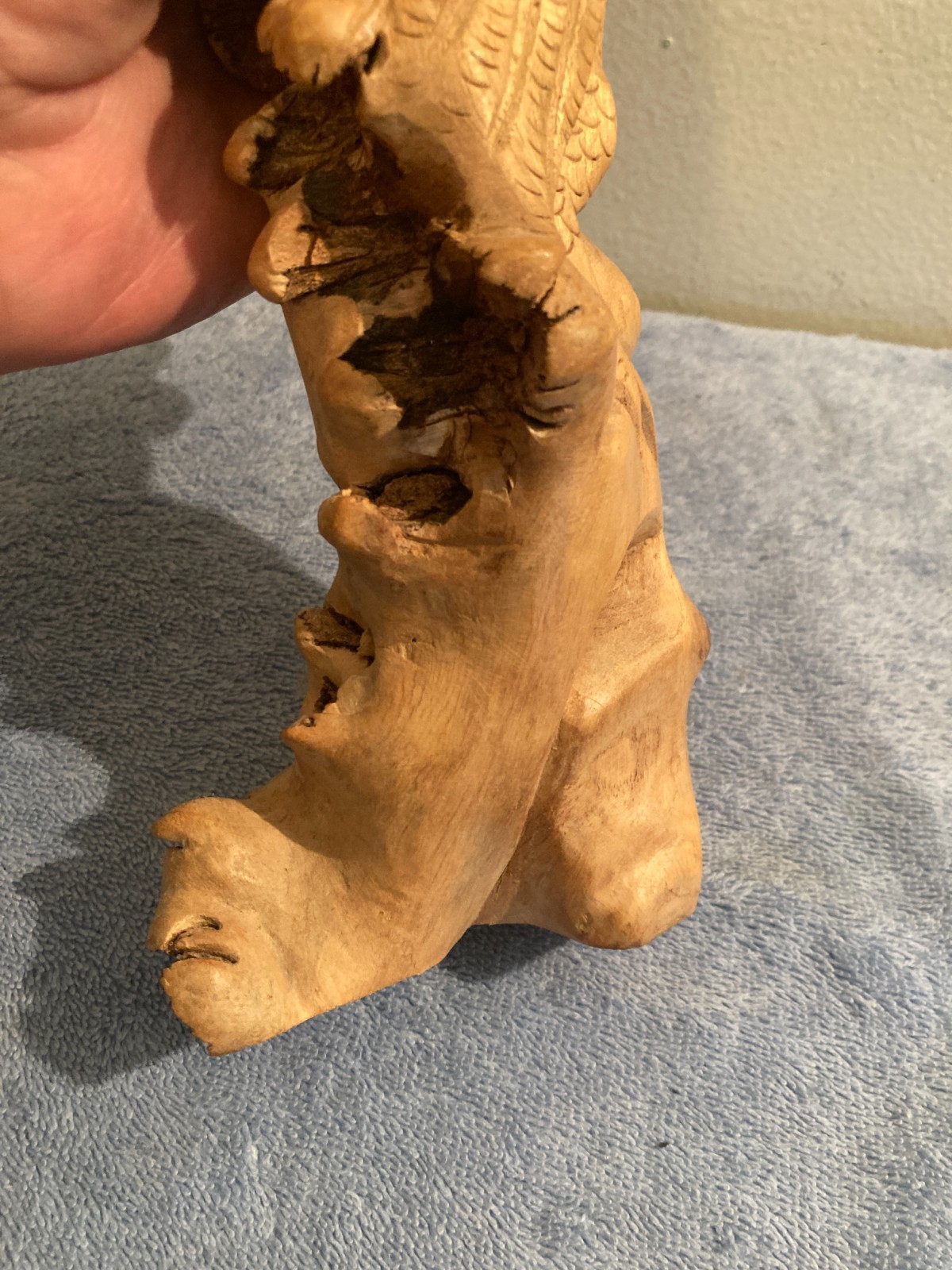 Owl bird statue hand carved from yellow natural wood with natural wood cracks