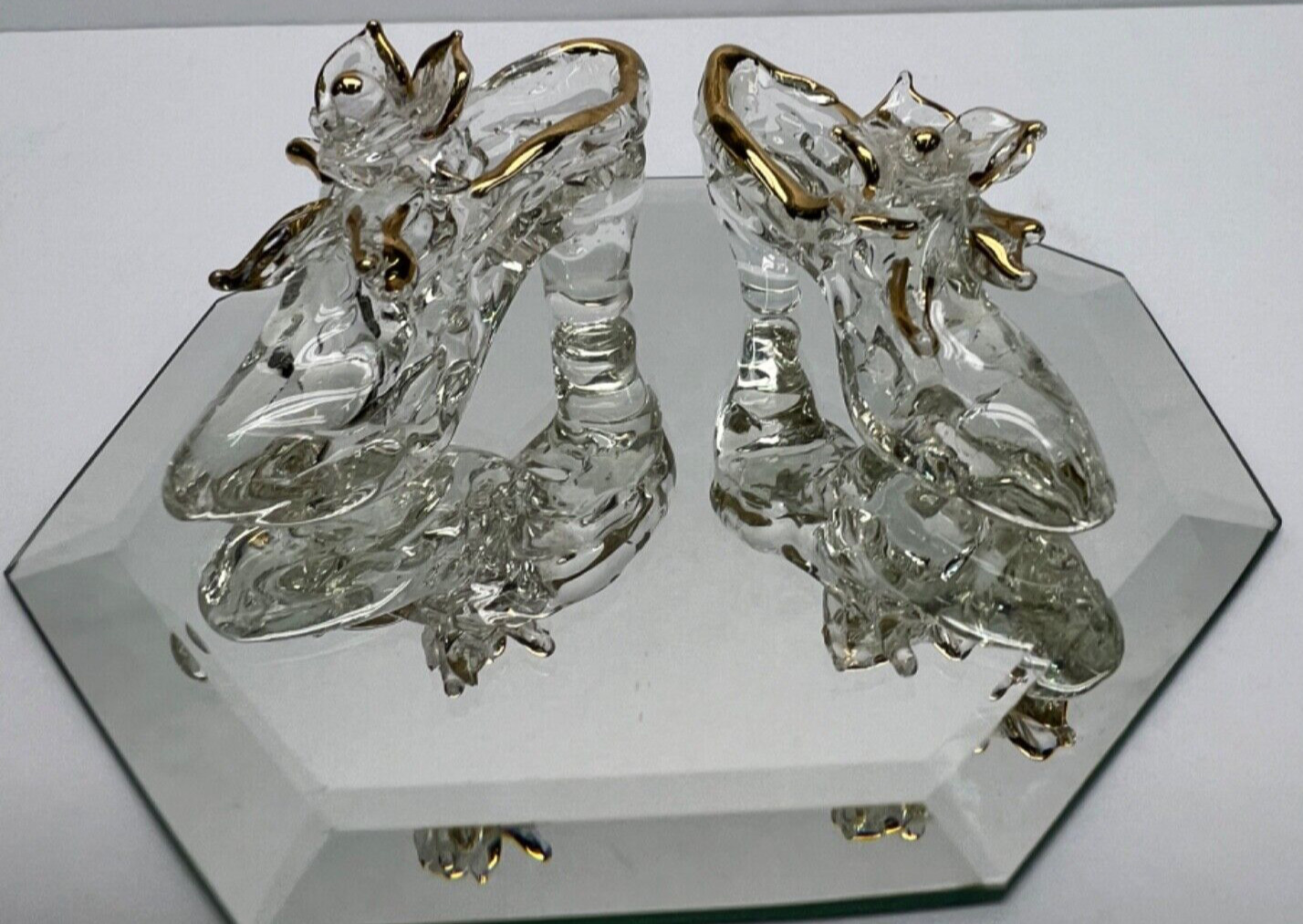 clear glass pair of high heel /slipper shoes with flower & gold trim on mirror