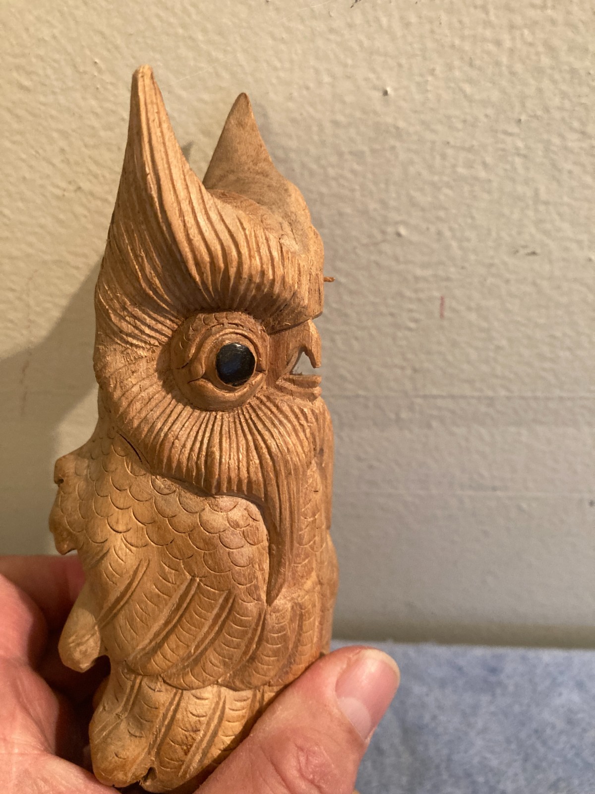 Owl bird statue hand carved from yellow natural wood with natural wood cracks