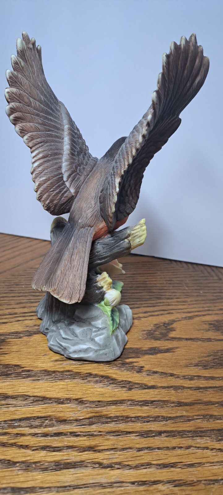 PORCELAIN ROBIN FIGURINE WITH FLOWER 7 5/8” H