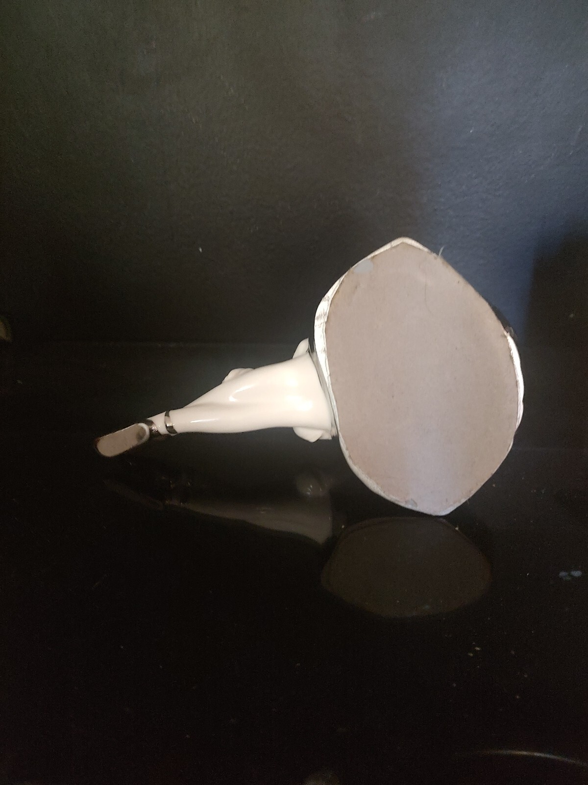 WHITE AND SILVER PORCELAIN SITTING BALLERINA FIGURINE. 9″L x 6″H X 5″W