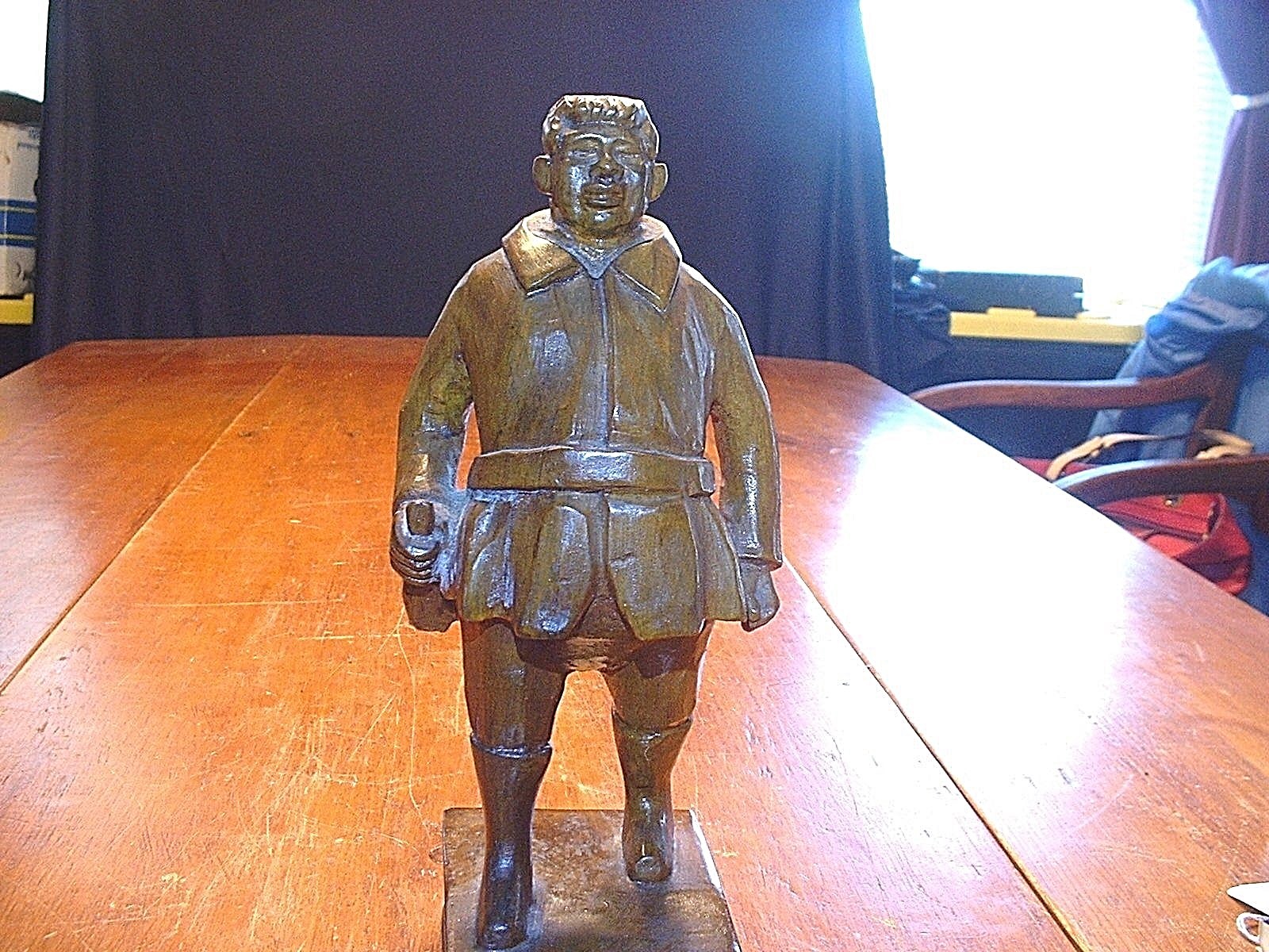 10 1/2″ Vintage German Black Forest Man Standing On Book With Wine Jug In Hand