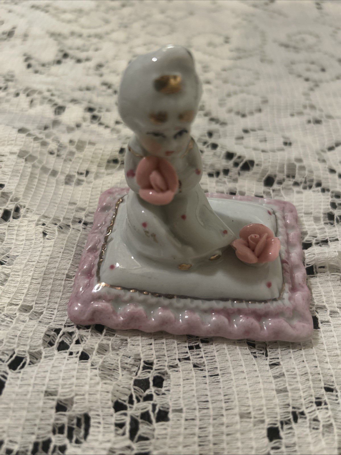 Girl On Pillow Holding A Pink Flower