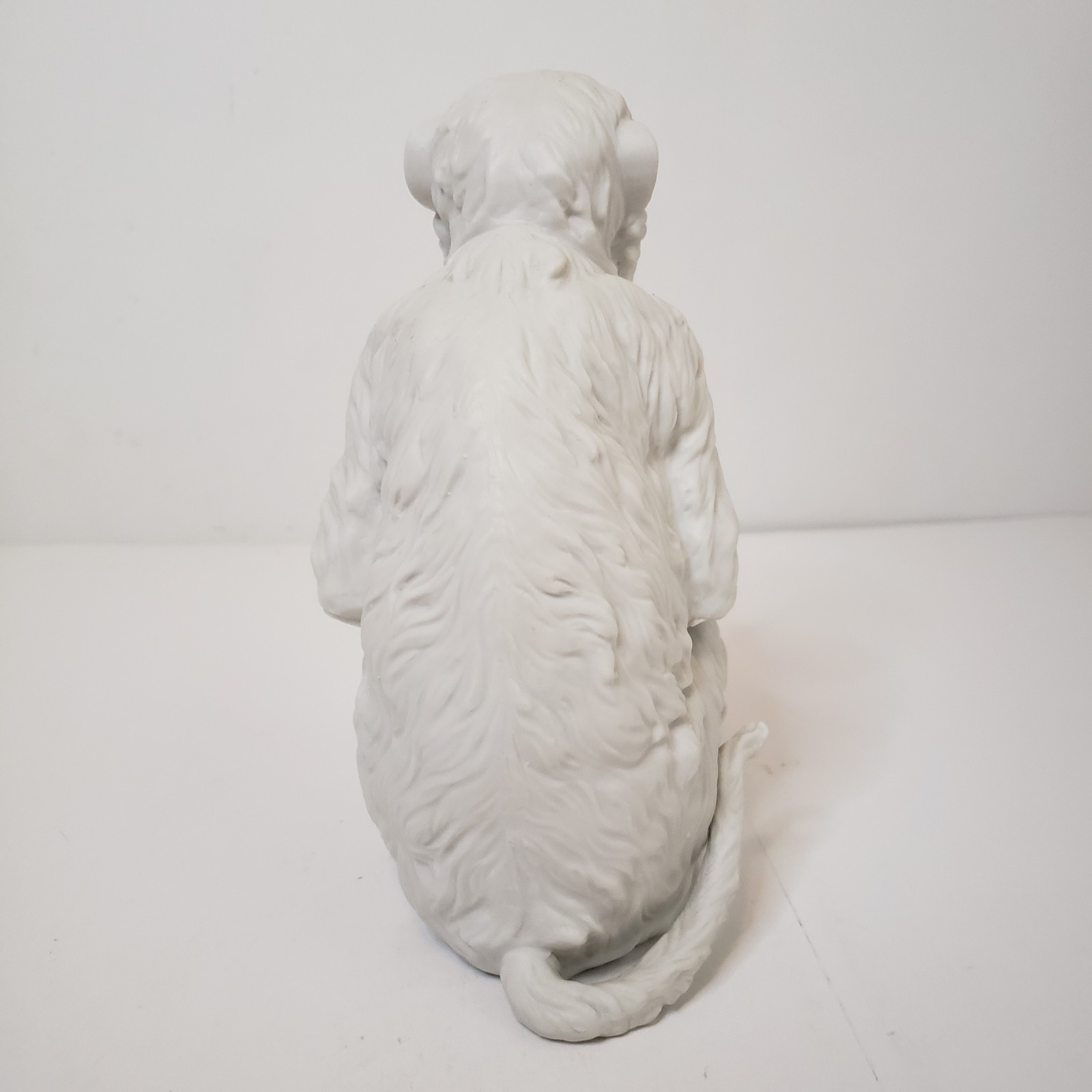 White Bisque Porcelain Sitting Monkey Holding Rock Figurine Vintage