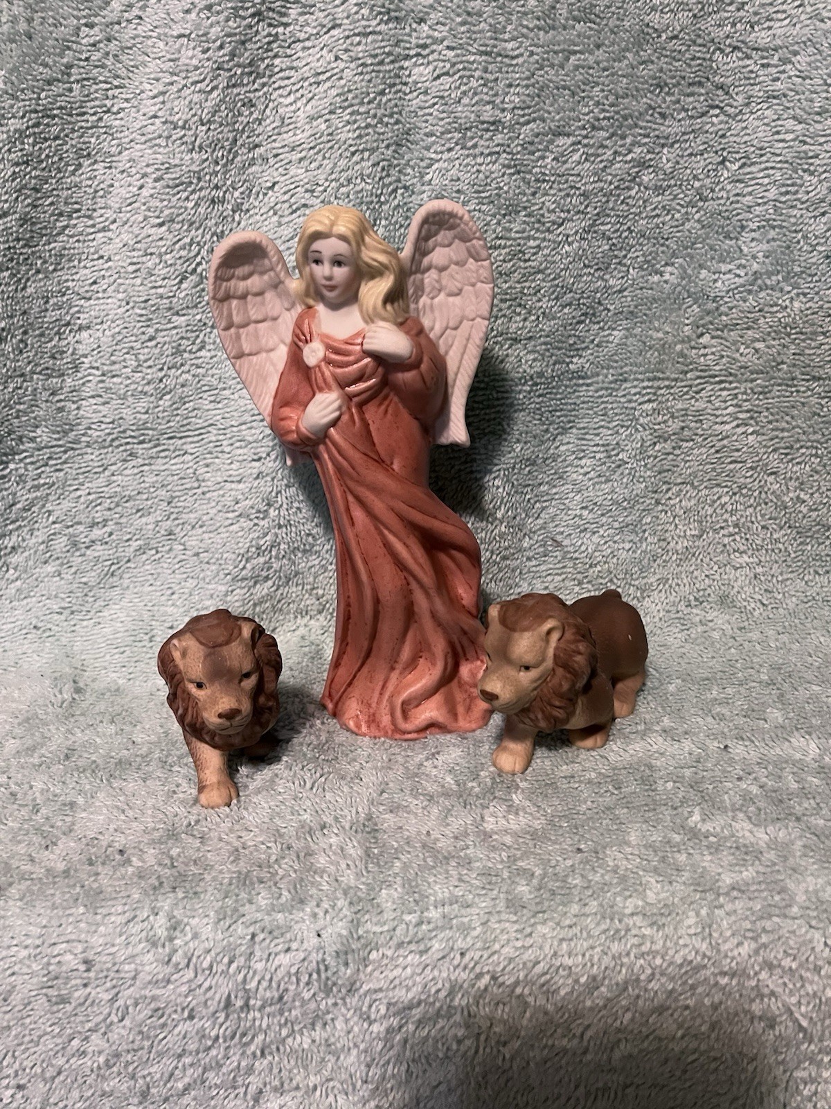 A Vintage Bisque Angle Figurine With Two Small Ceramic Lions