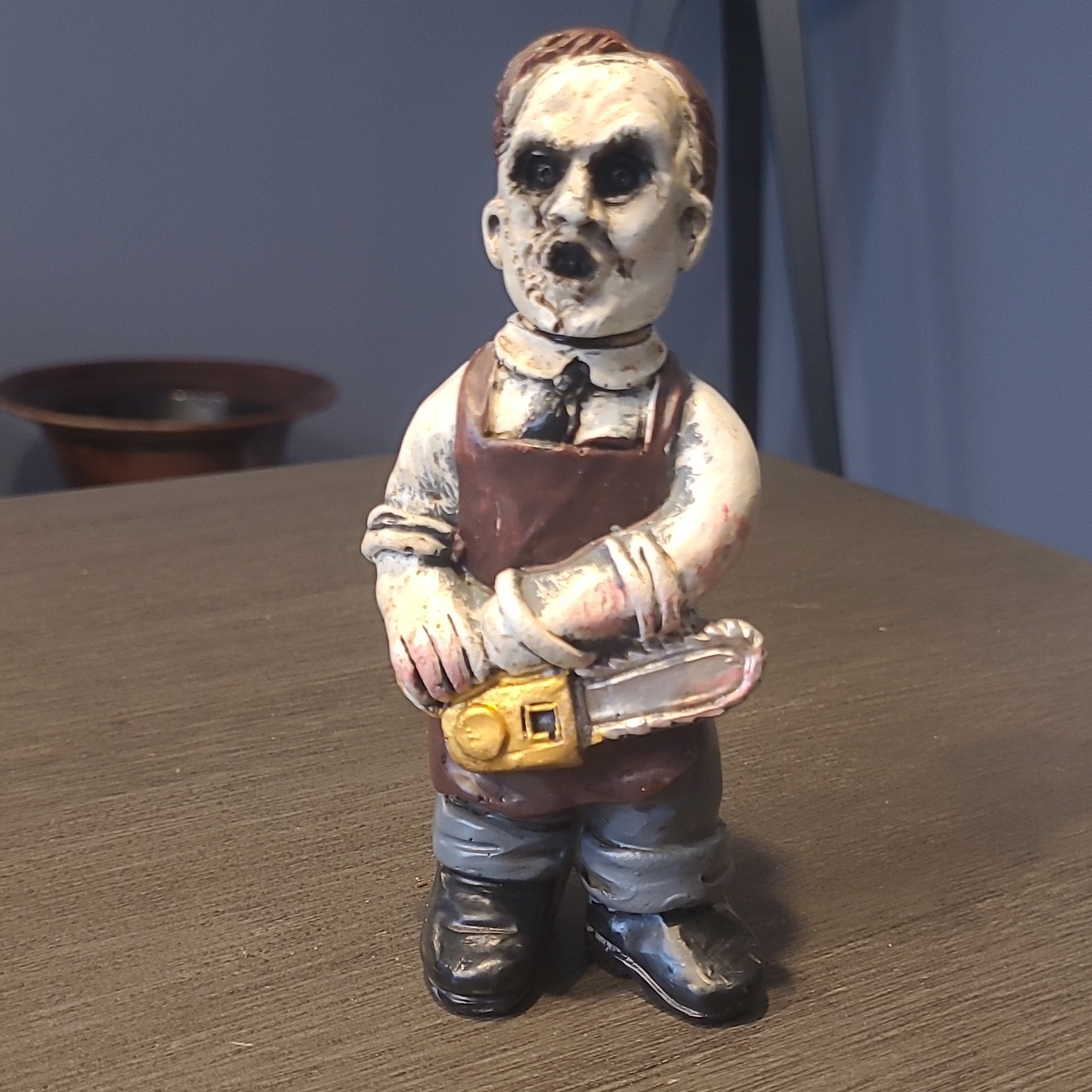 Hand Painted Matte Ceramic Lumberjack Boy Figurine w/ Chainsaw. 5″ tall.
