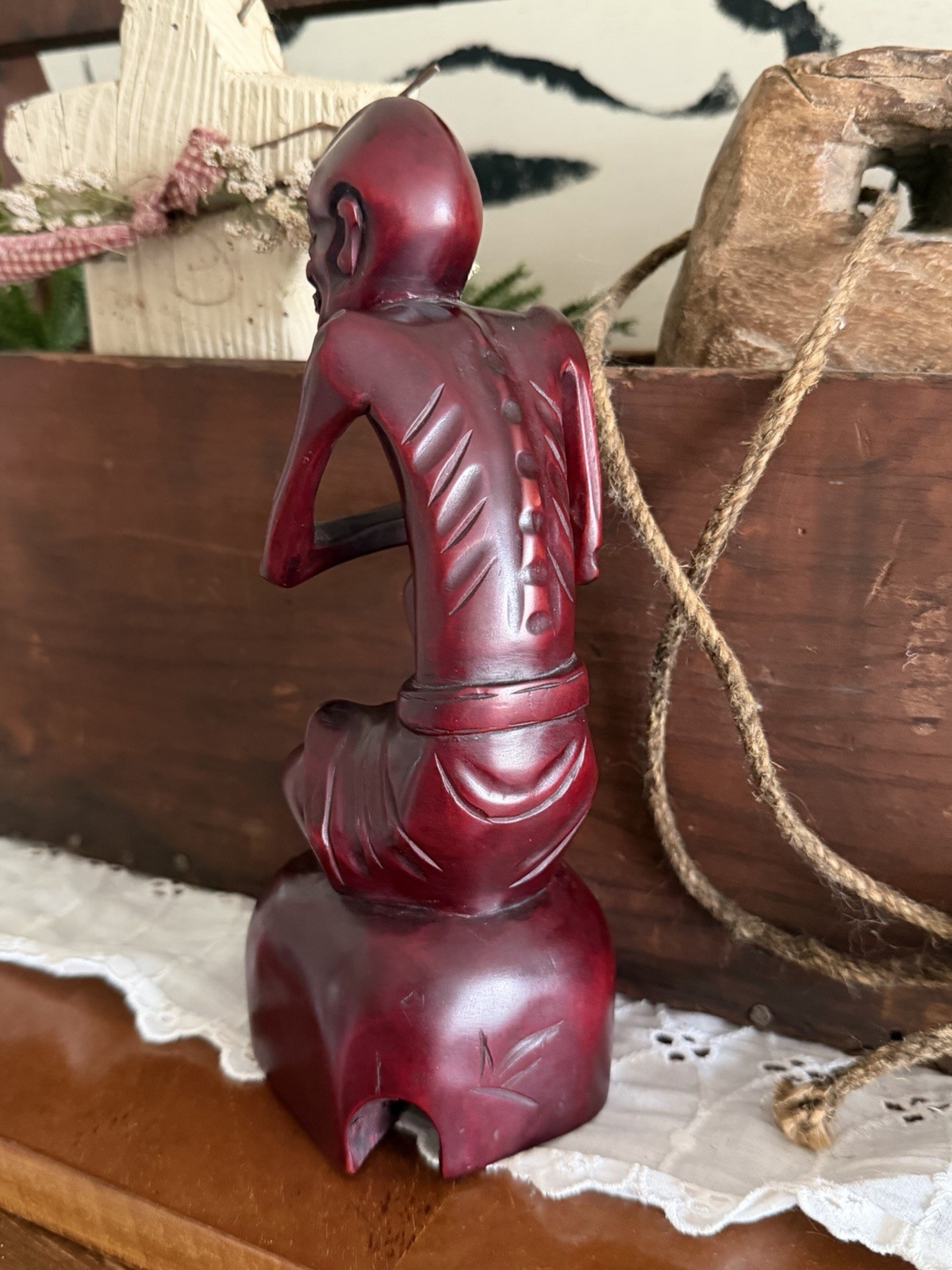 vintage hand-carved wood statue, often referred to as a “Fasting Buddha”