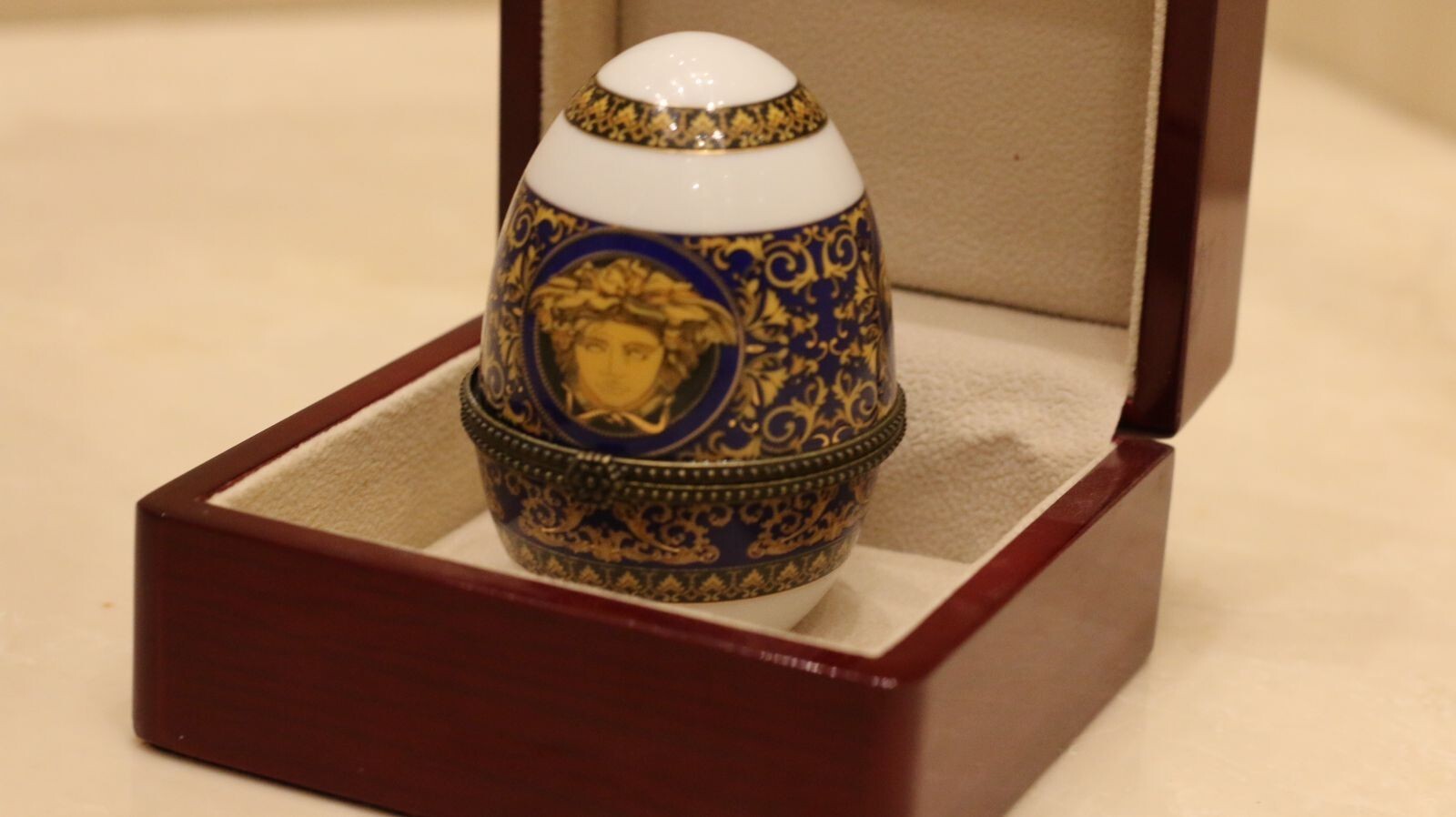 Versace Designs egg in white bohemian porcelain with blue and gold Medusa