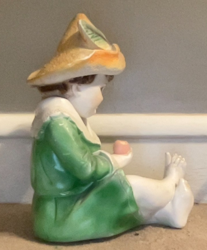 Large Ceramic or Chalk Figurine. Young Boy Holding an Apple. 12″ x 7″.