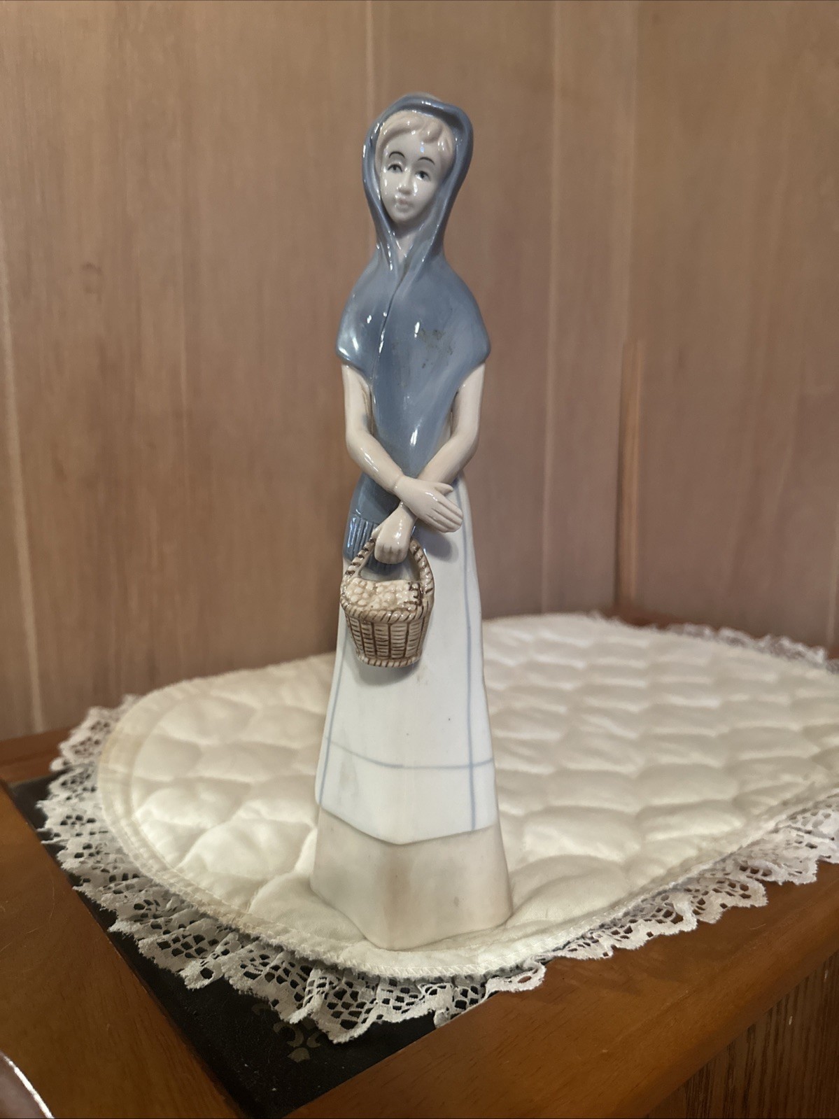 Woman figurine porcelain village lady holding basket Unsigned Vintage