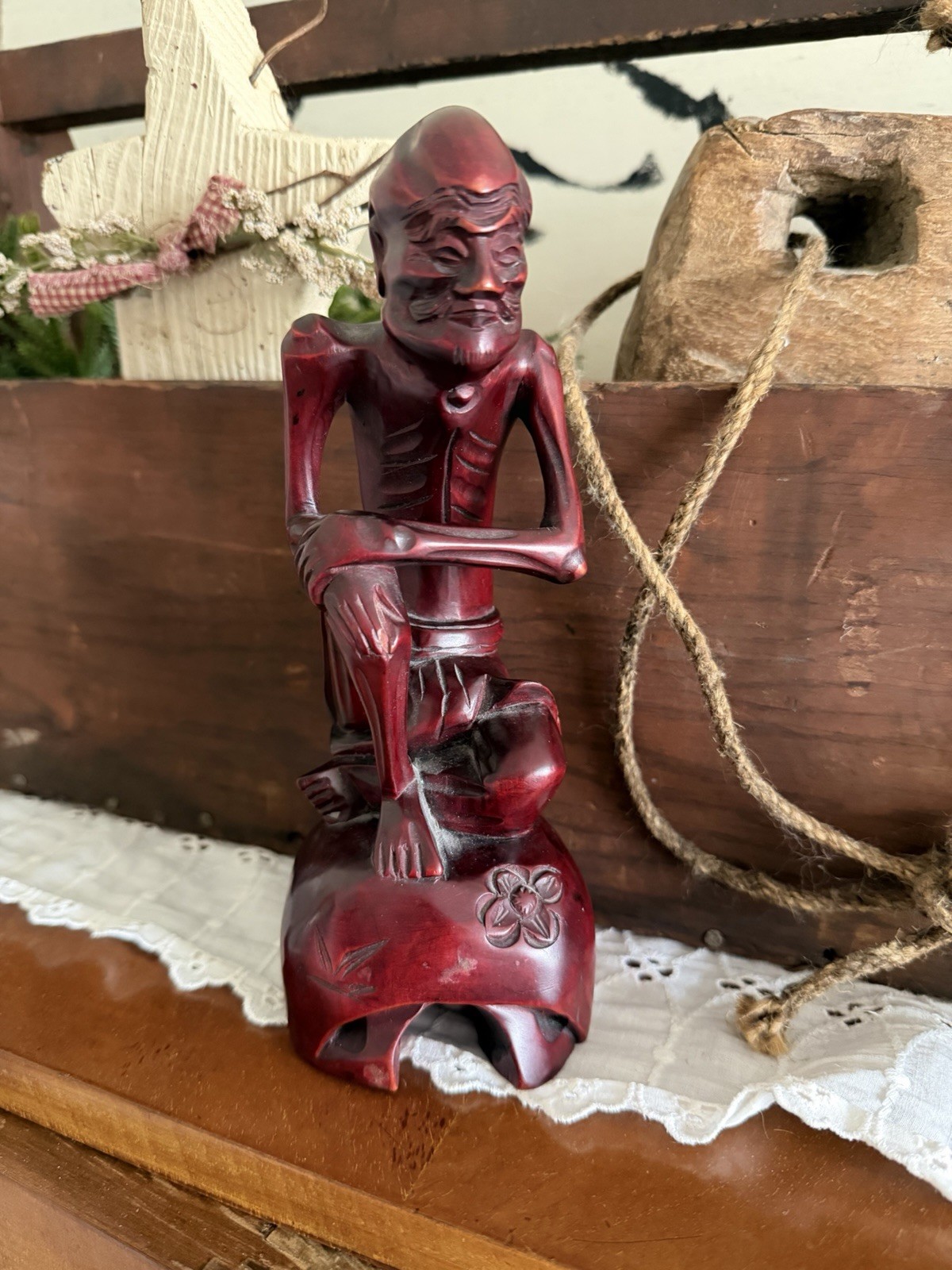 vintage hand-carved wood statue, often referred to as a “Fasting Buddha”
