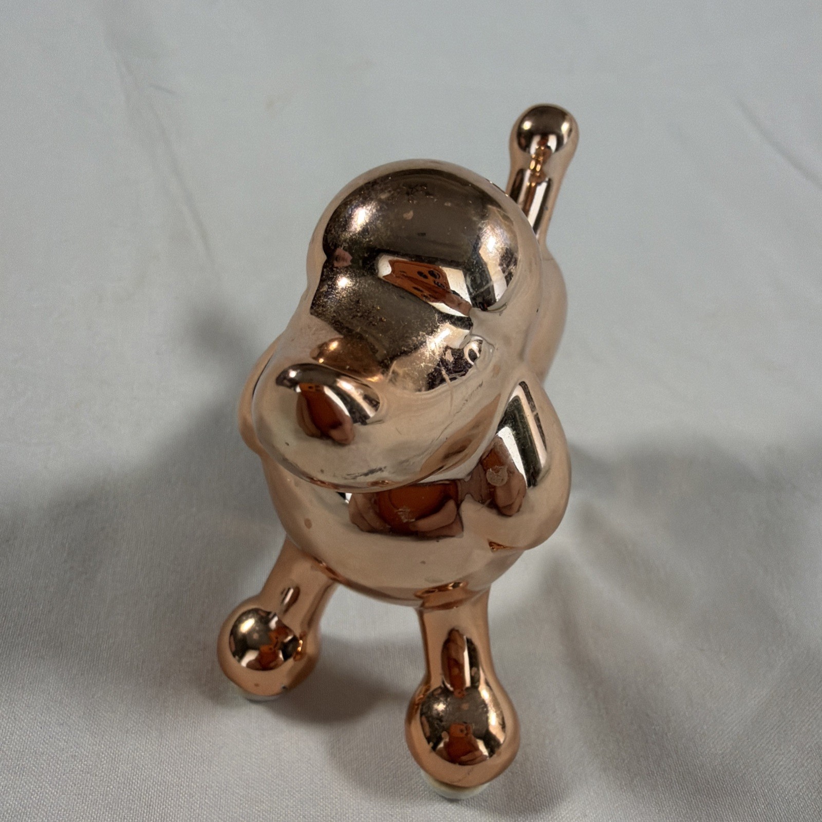 Ceramic metallic rose gold balloon dog figurine.