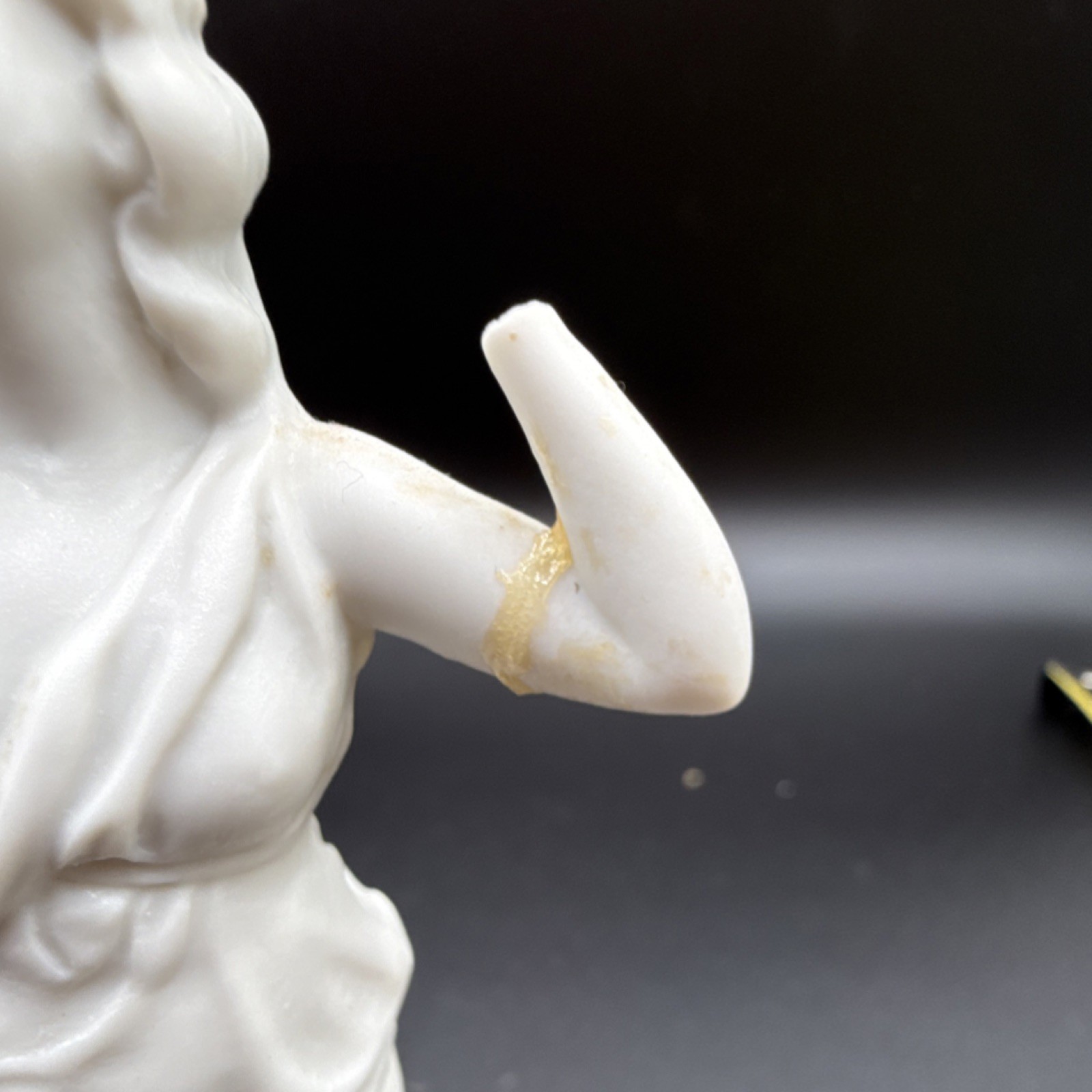 White porcelain figurine of a woman with carvings and matte finish, 6 in