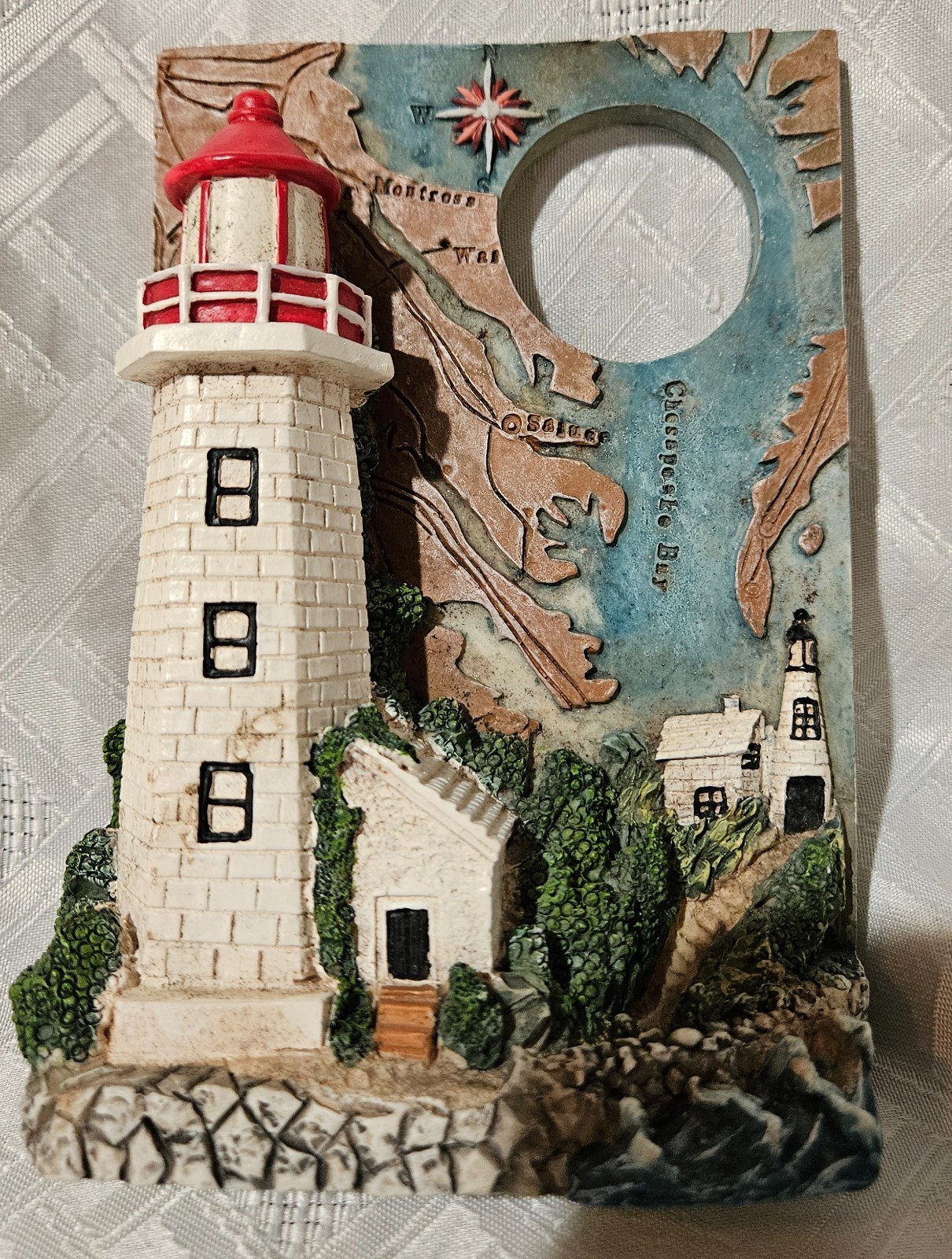 Vintage Lighthouse Plaque that features a map background of Chespeake Bay .