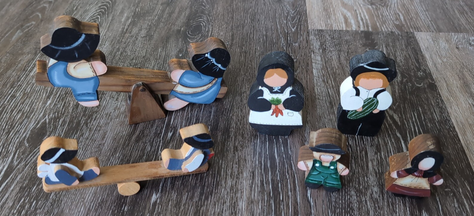 Lot Of Wooden Amish Figurines Including two children on two seesaws