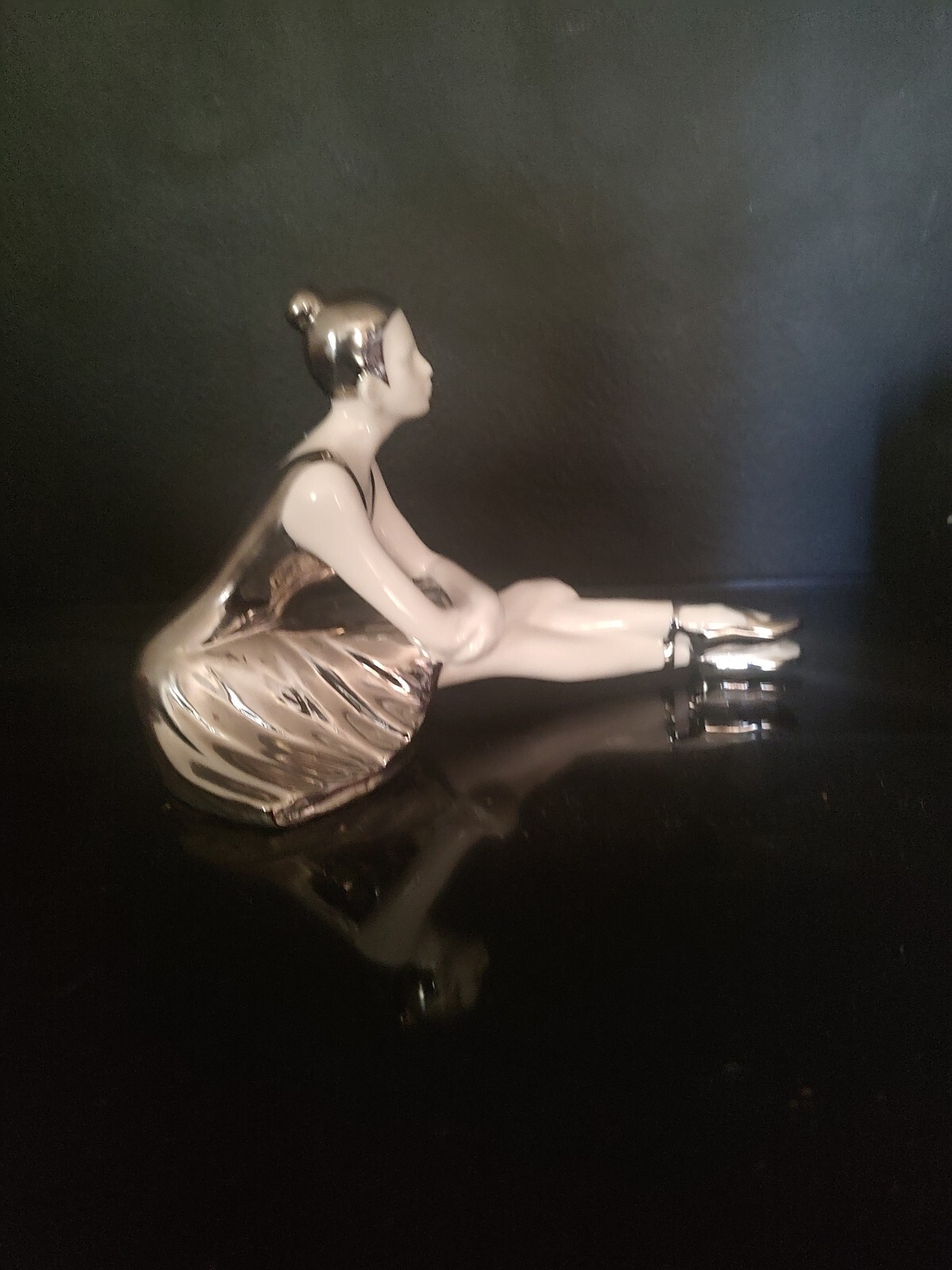 WHITE AND SILVER PORCELAIN SITTING BALLERINA FIGURINE. 9″L x 6″H X 5″W