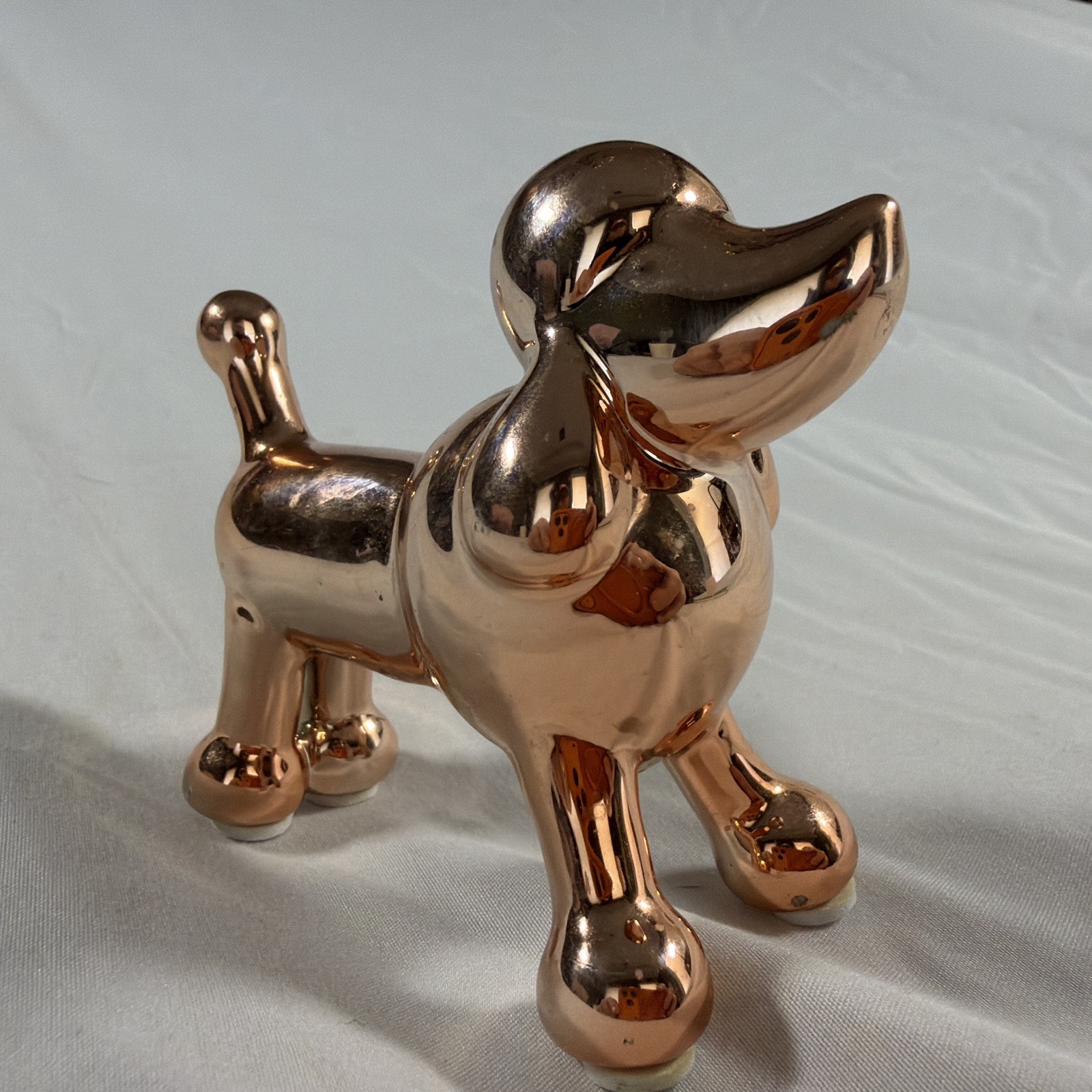 Ceramic metallic rose gold balloon dog figurine.