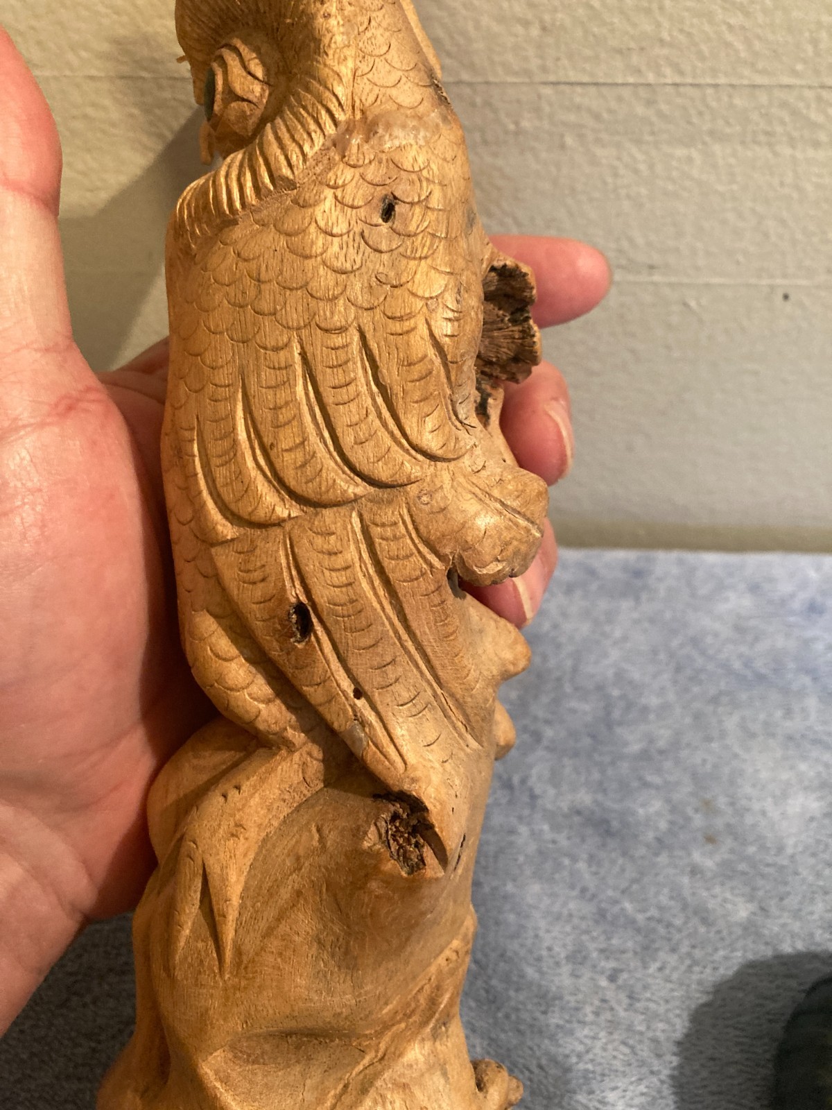 Owl bird statue hand carved from yellow natural wood with natural wood cracks