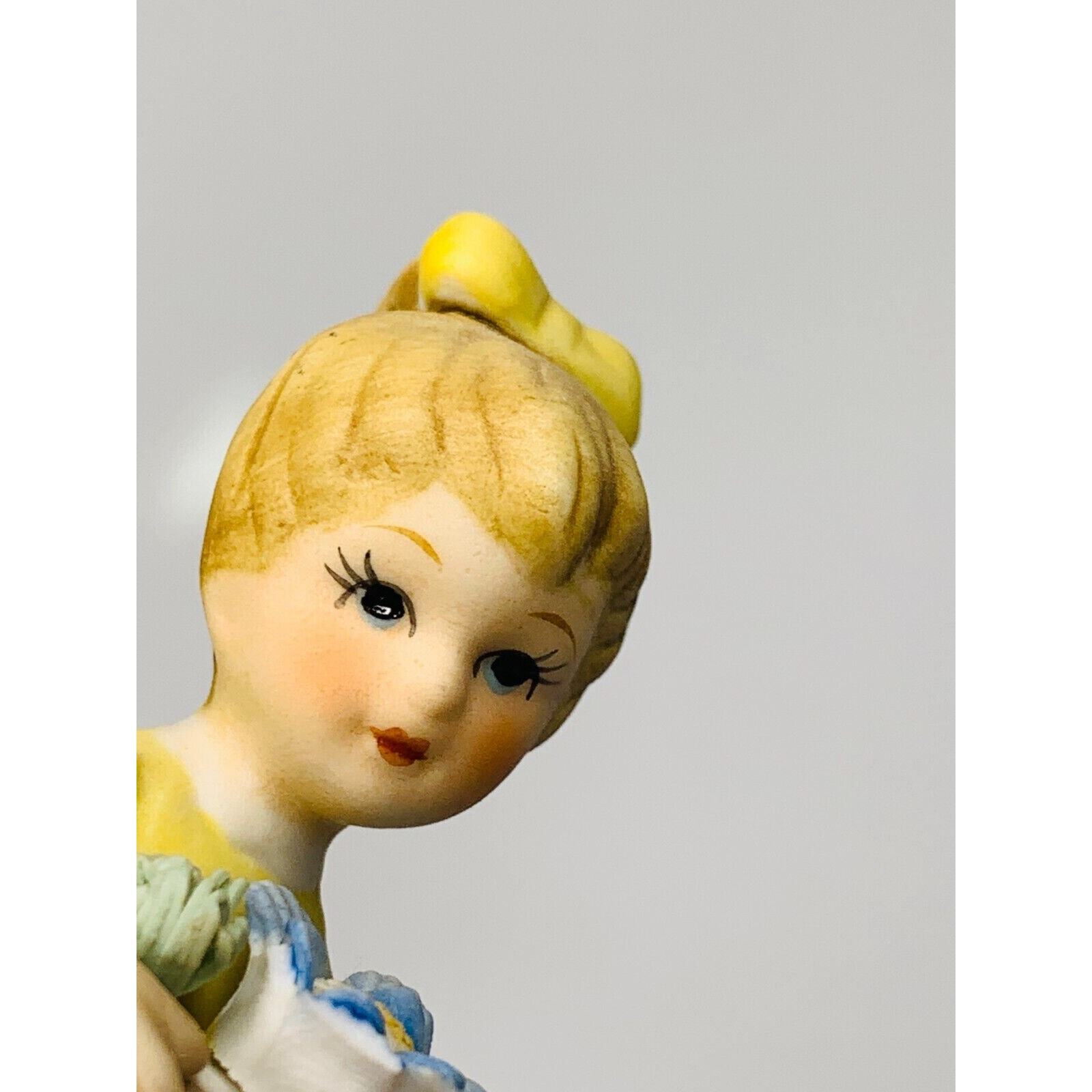 Napco Girl Figurine Yellow Dress and Bow With Blue Flower #8614