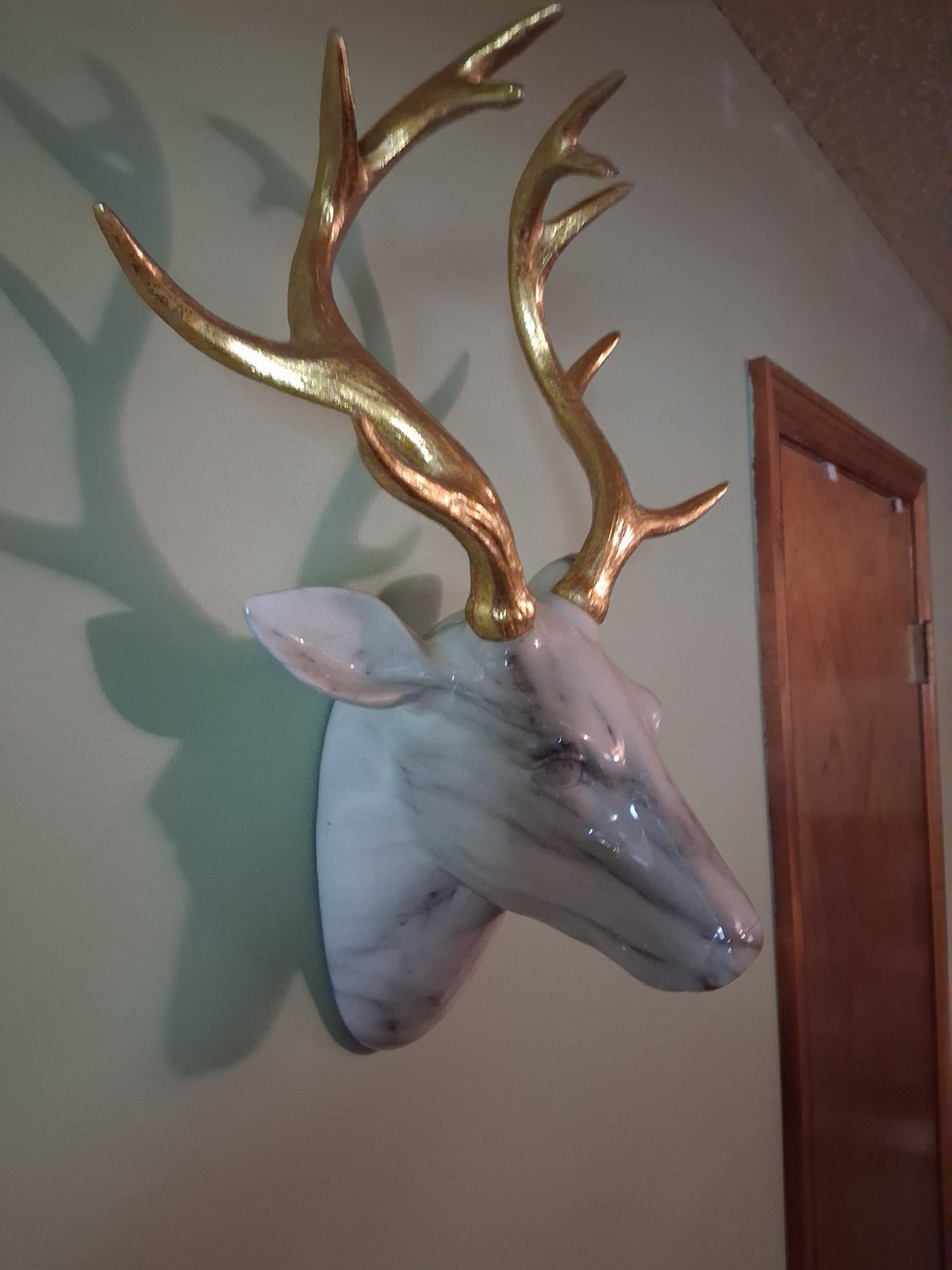 White Marbled Deer Head Hangs On Wall With Gold Antlers About 18″ Tall