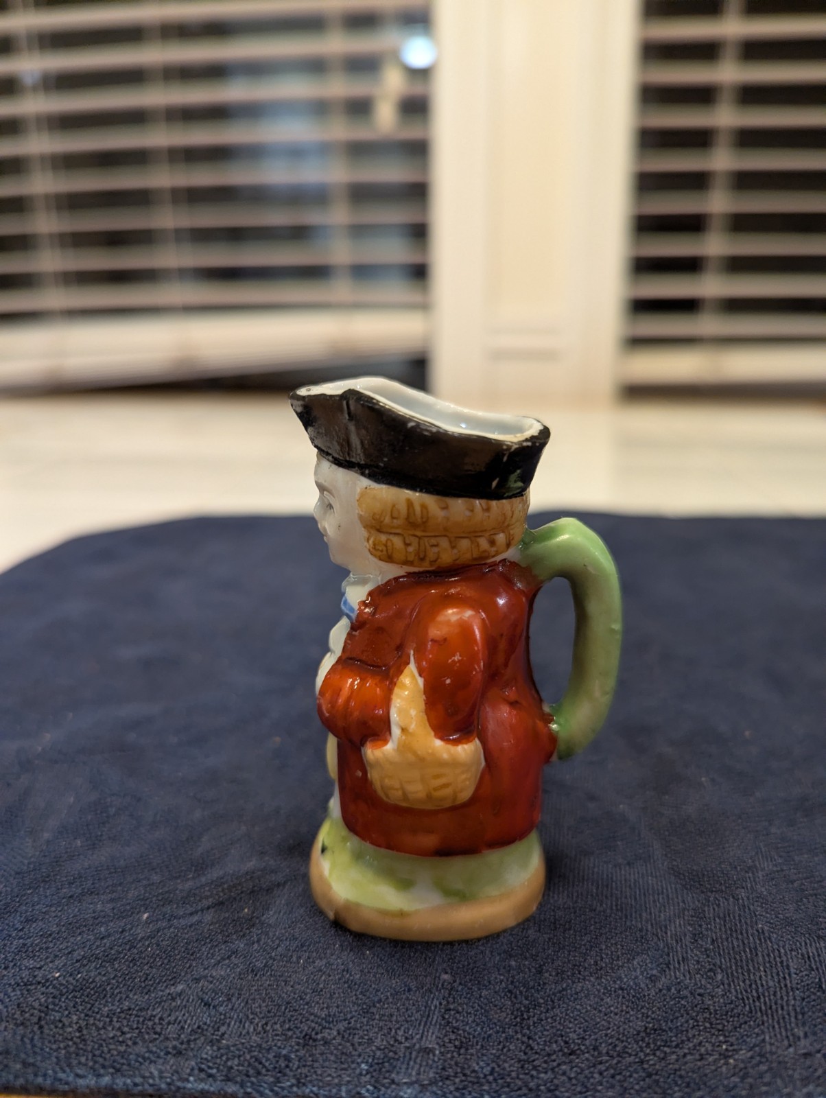 Two Mid-century Porcelain Colonial Figures Including A Small Toby Jug.