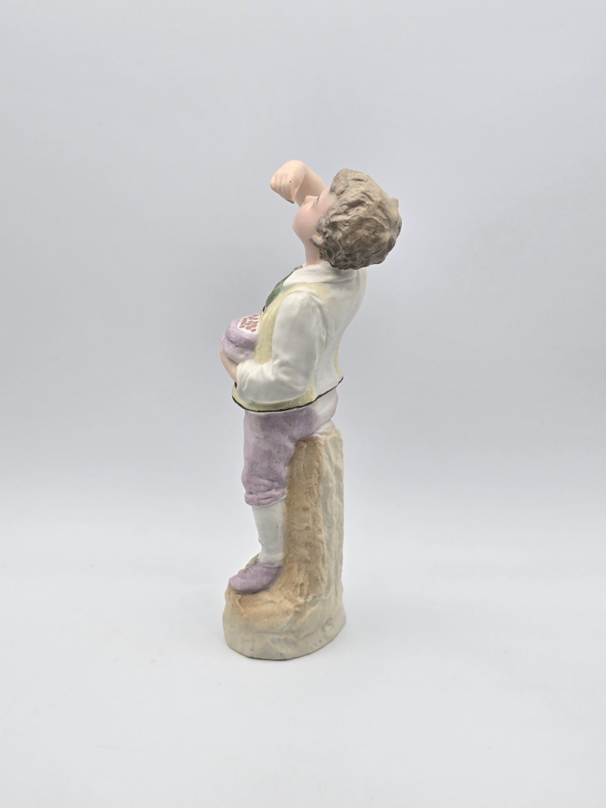 Vintage Gebruder Heubach Figurine 10″ Tall. Young Boy Eating Fruit From His Bag