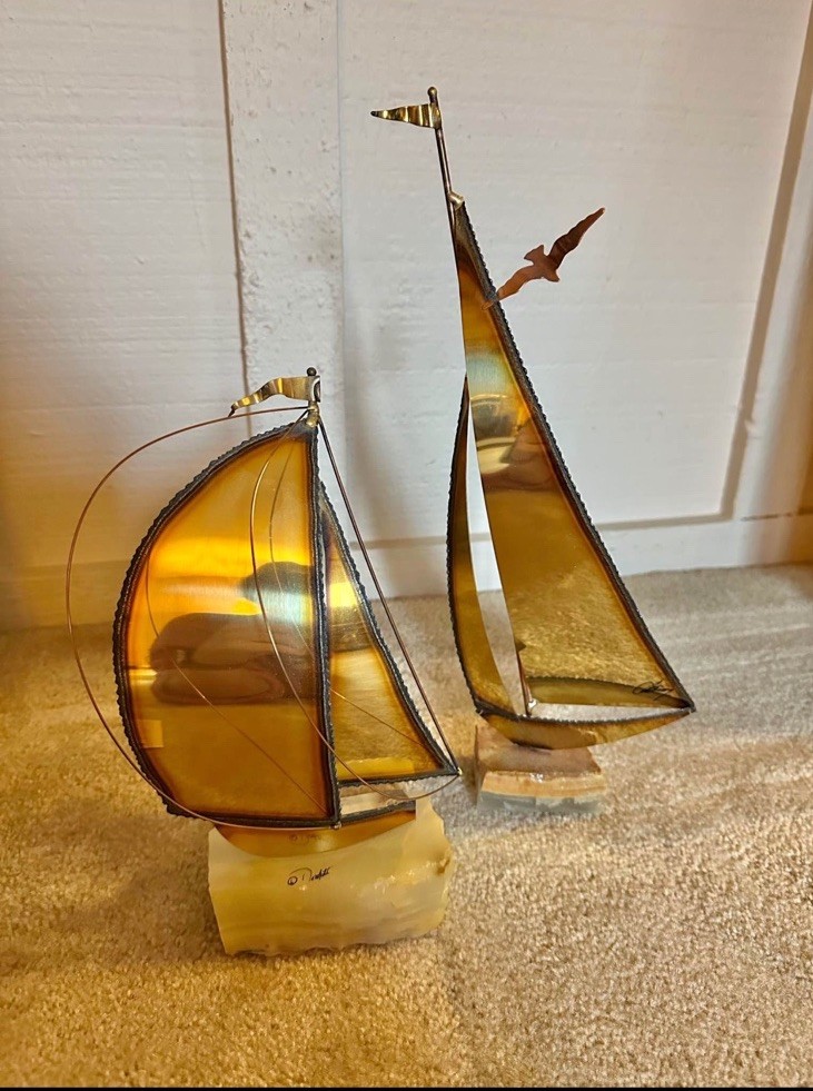 Vintage DeMott metal and glass sailboat sculptures on onyx bases.