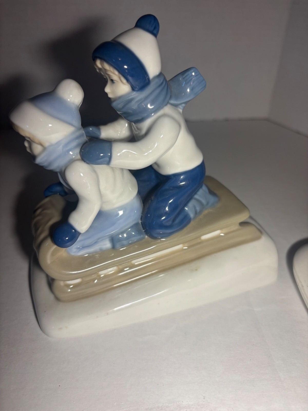 Children Sledding Figurine 6″L glazed ceramic gray & blue winter Christmas