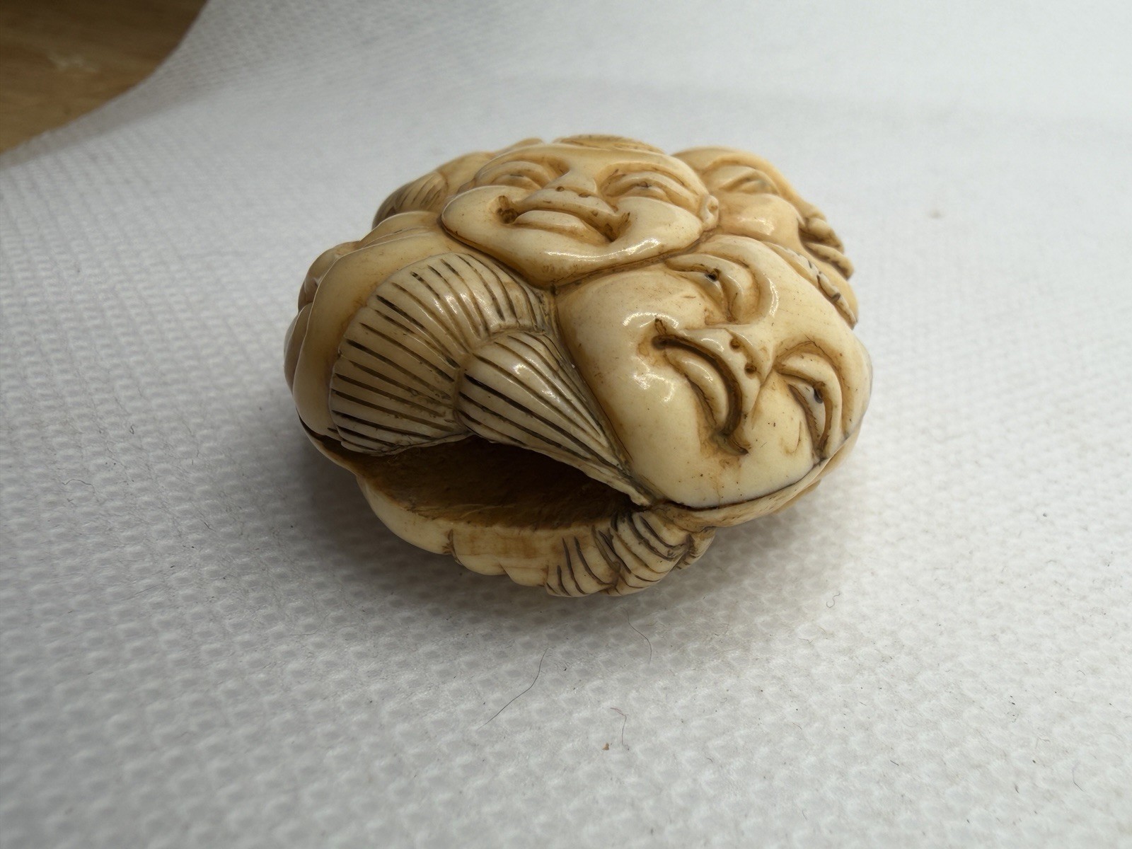Japanese Carved Netsuke – Circular With Many Happy Faces And Geometric Shapes