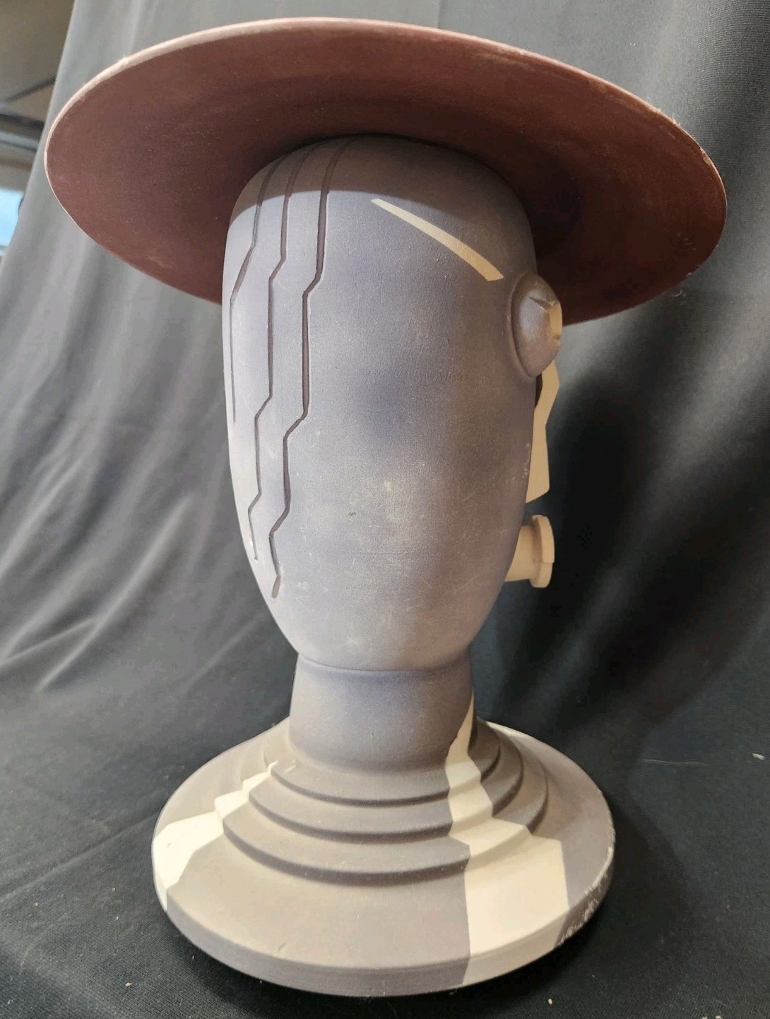Design: The piece features an abstract, modernist design with simplified facial