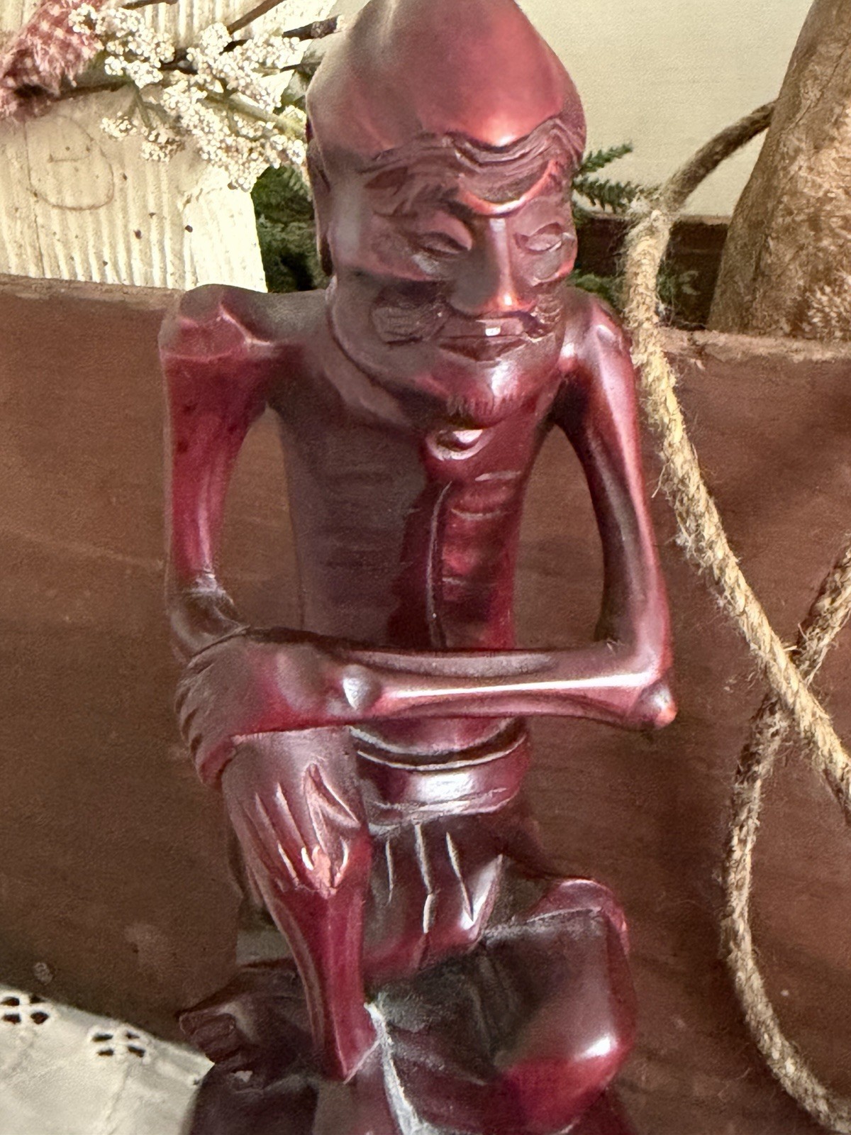vintage hand-carved wood statue, often referred to as a “Fasting Buddha”