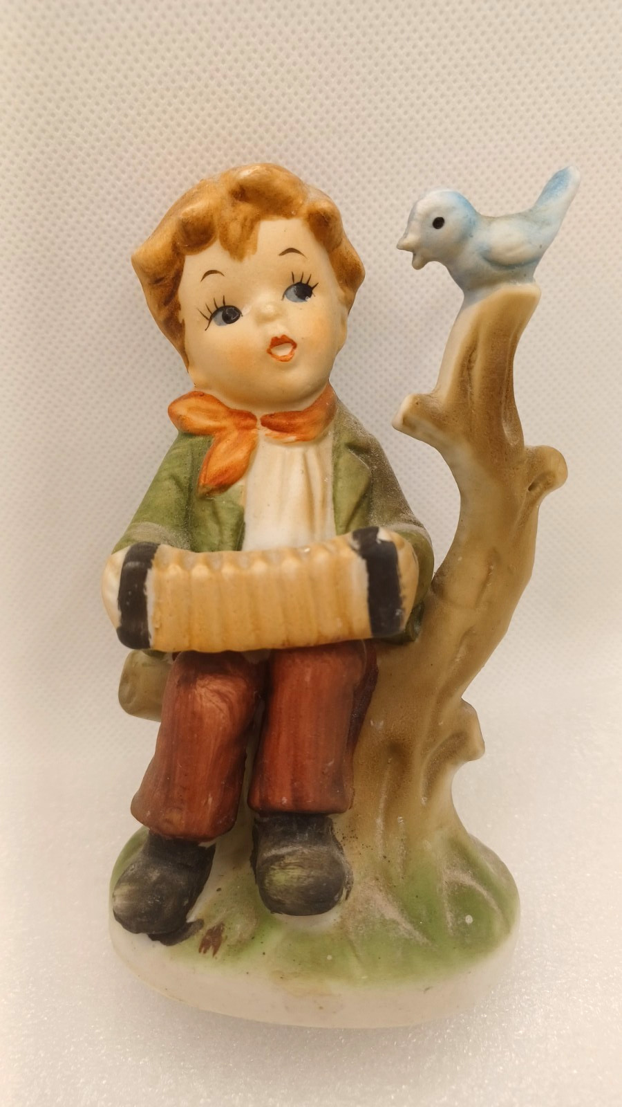 VTG YOUNG BOY PLAYING AN ACCORDIAN TO A BLUE BIRD ON A BRANCH-4 3/4″ TALL
