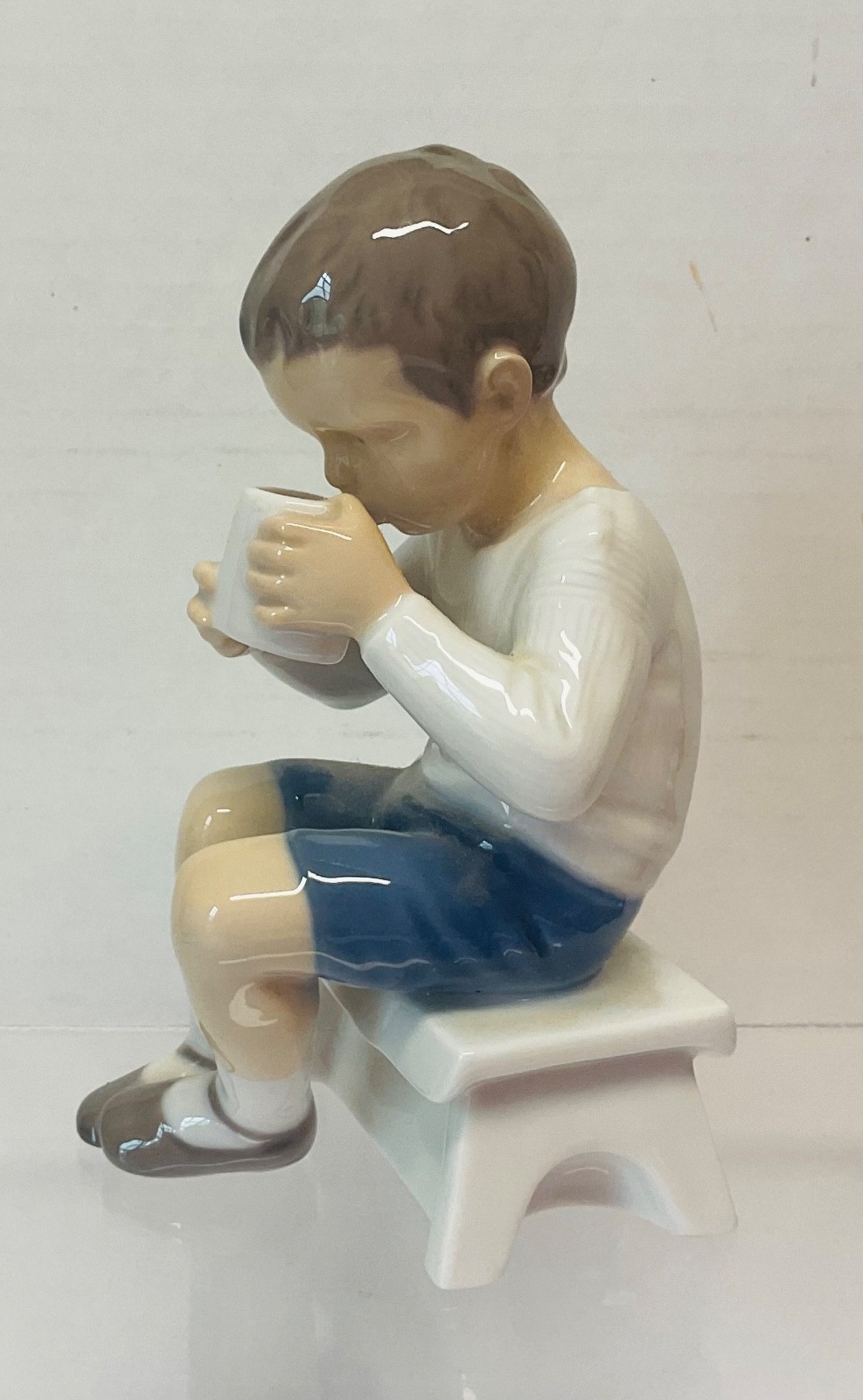 Adorable vintage BING & GRONDAHL #1713 Seat Boy Drinking Cup of Milk Figurine