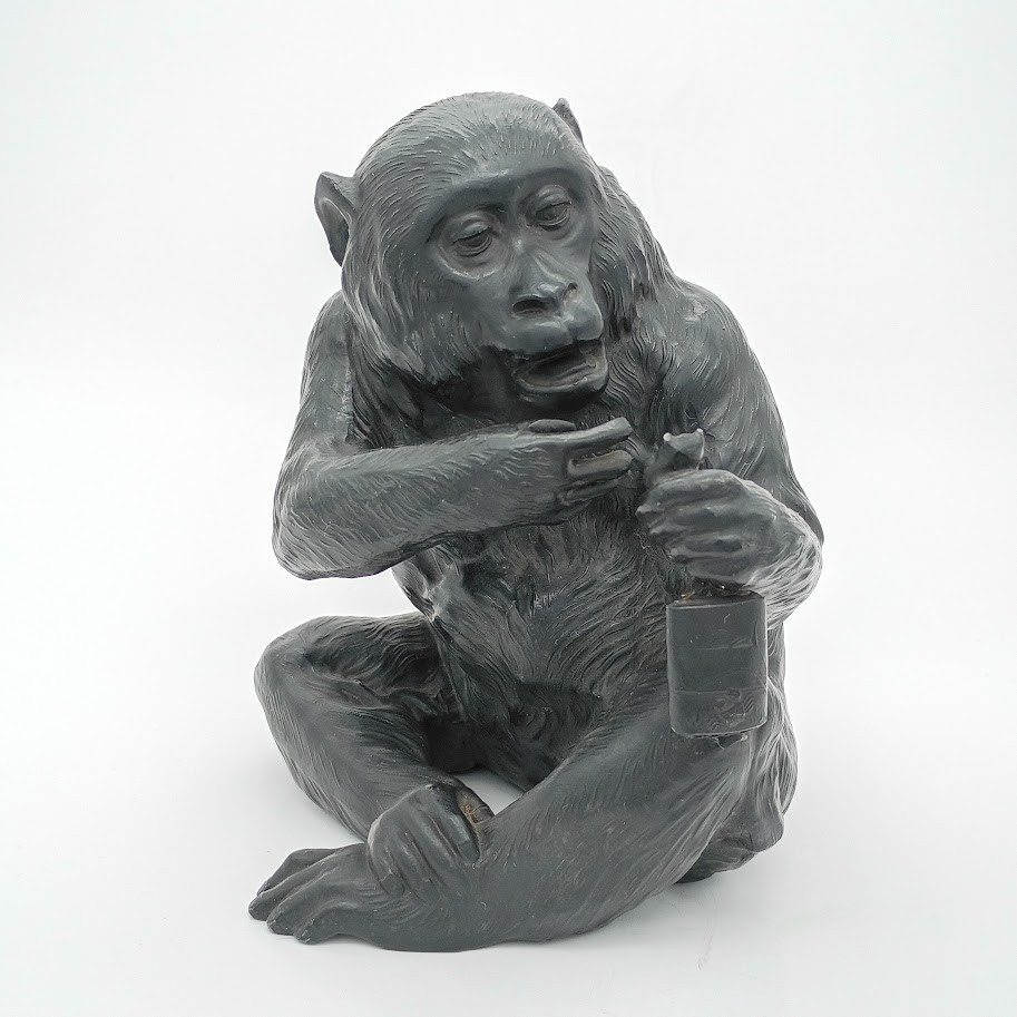 Bronze finished 1920’s figure of a seated monkey