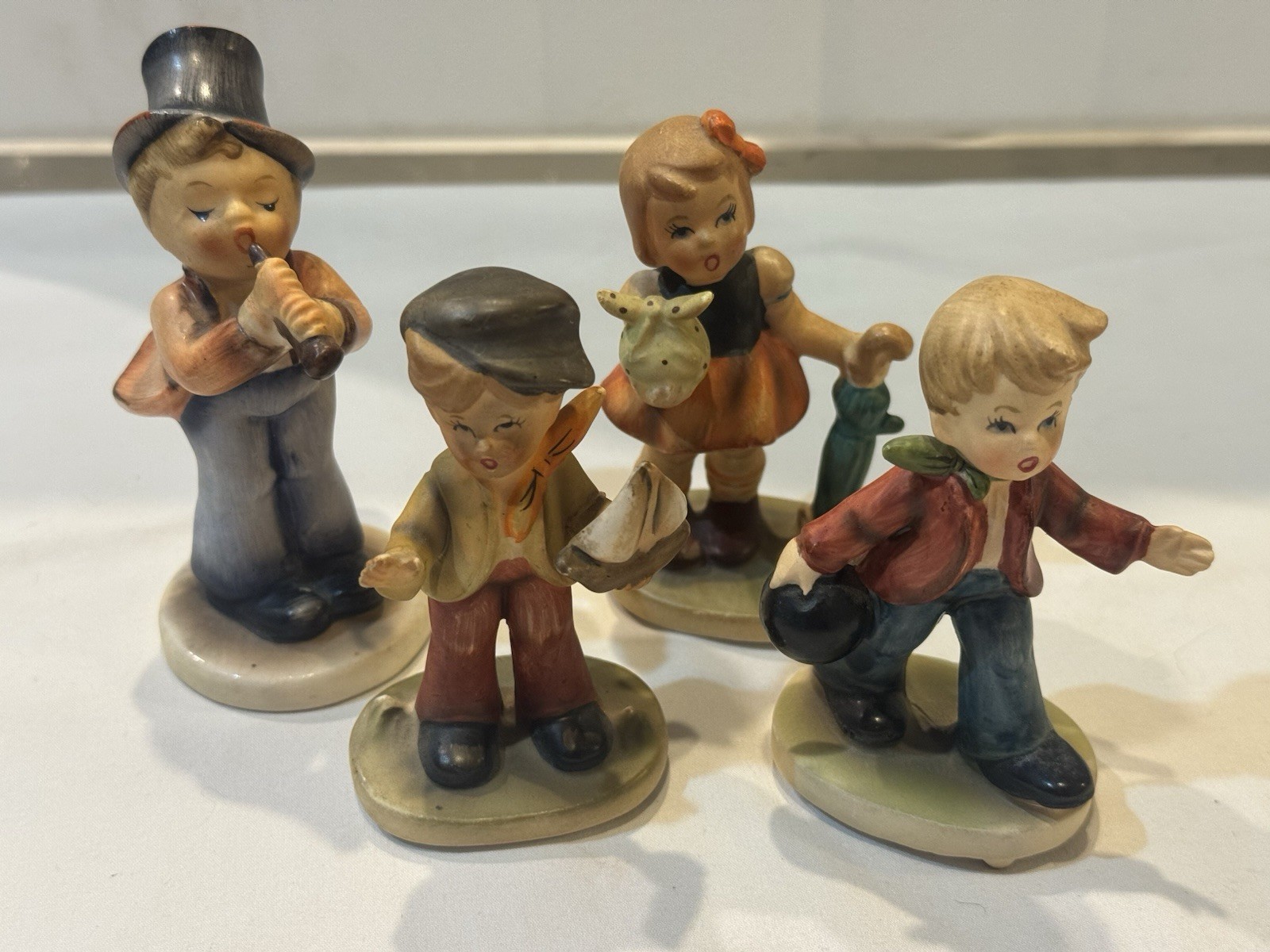 VNTG Lot of 4 Napcoware Porcelain Figurines- Bowling, Sailboat, Flute, Umbrella