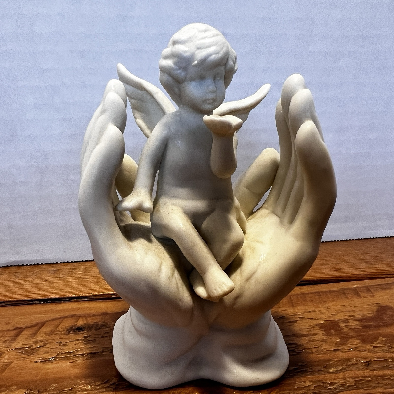 Vintage White Porcelain Figurine~Cherub Angel Sitting in Praying Hands~BEAUTIFUL