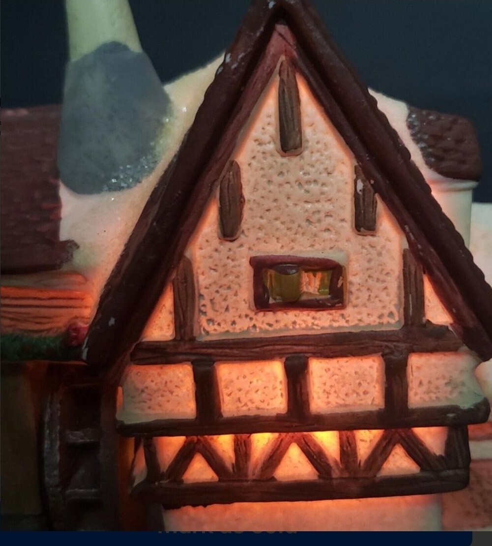 Charming Handcrafted Millhouse Figurine with Snow-Capped Roof and Flowing Water.