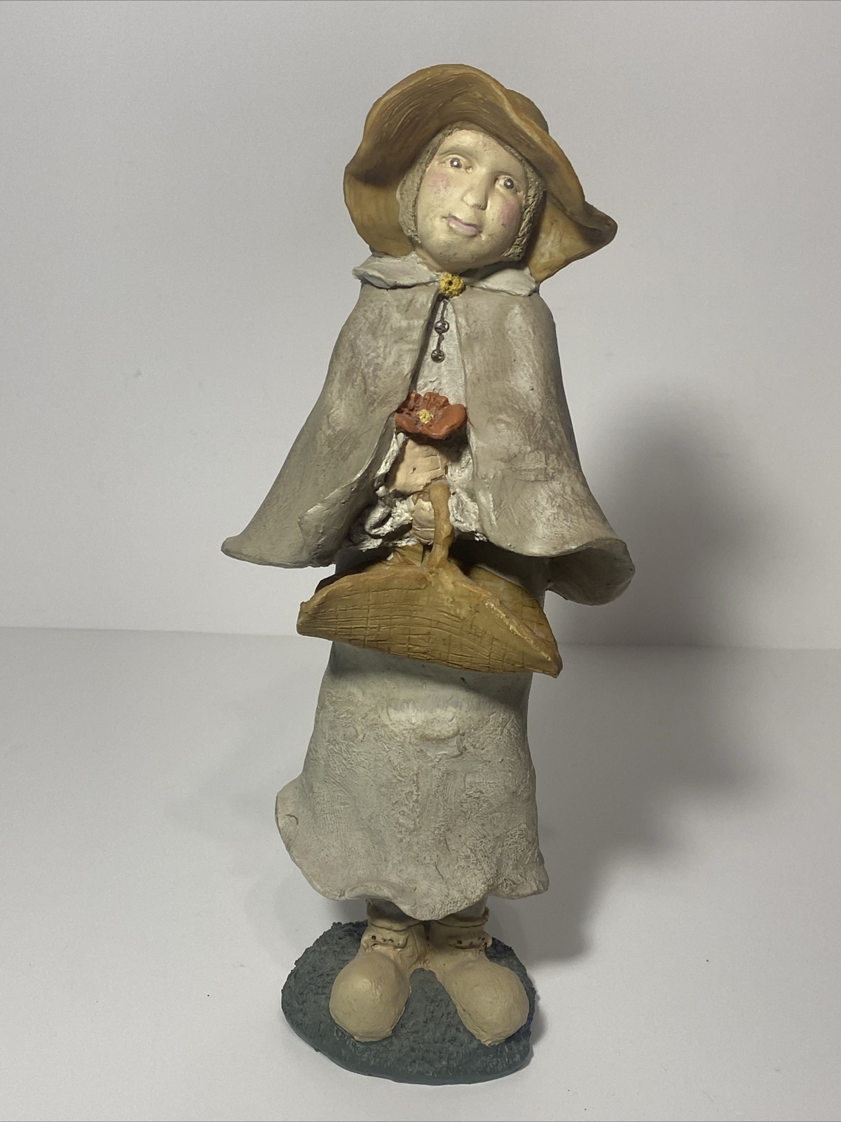 Decorative Figurine Lady With Basket Holding A Flower- Approx. 11 Inches Tall.