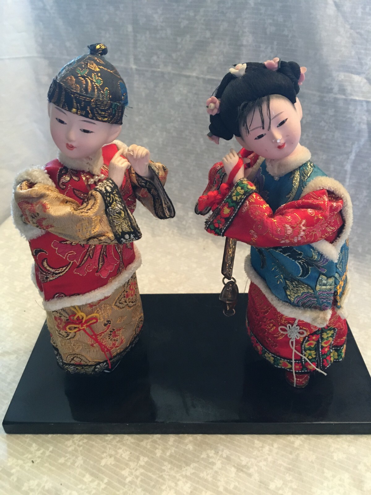 figurine dolls Chinese figures boy and girl. Silk outfits. Holding a bronze
