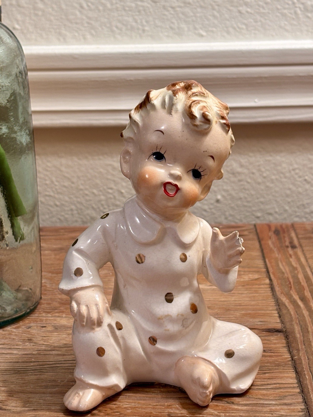 Vintage Napco porcelain baby figurine in gold-dotted pajamas.