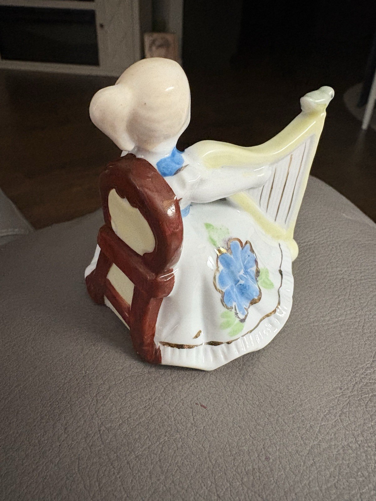 vintage porcelain figurine of a woman playing a harp